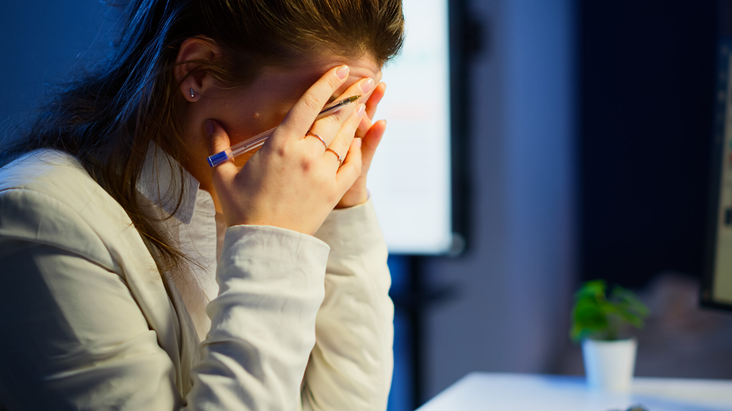 Close Up Stressed Busy Woman With Headache Working From Business Office Late Night Tired Focused Employee Using Modern Technology Network Wireless Doing Overtime Job Checking Reports Scaled