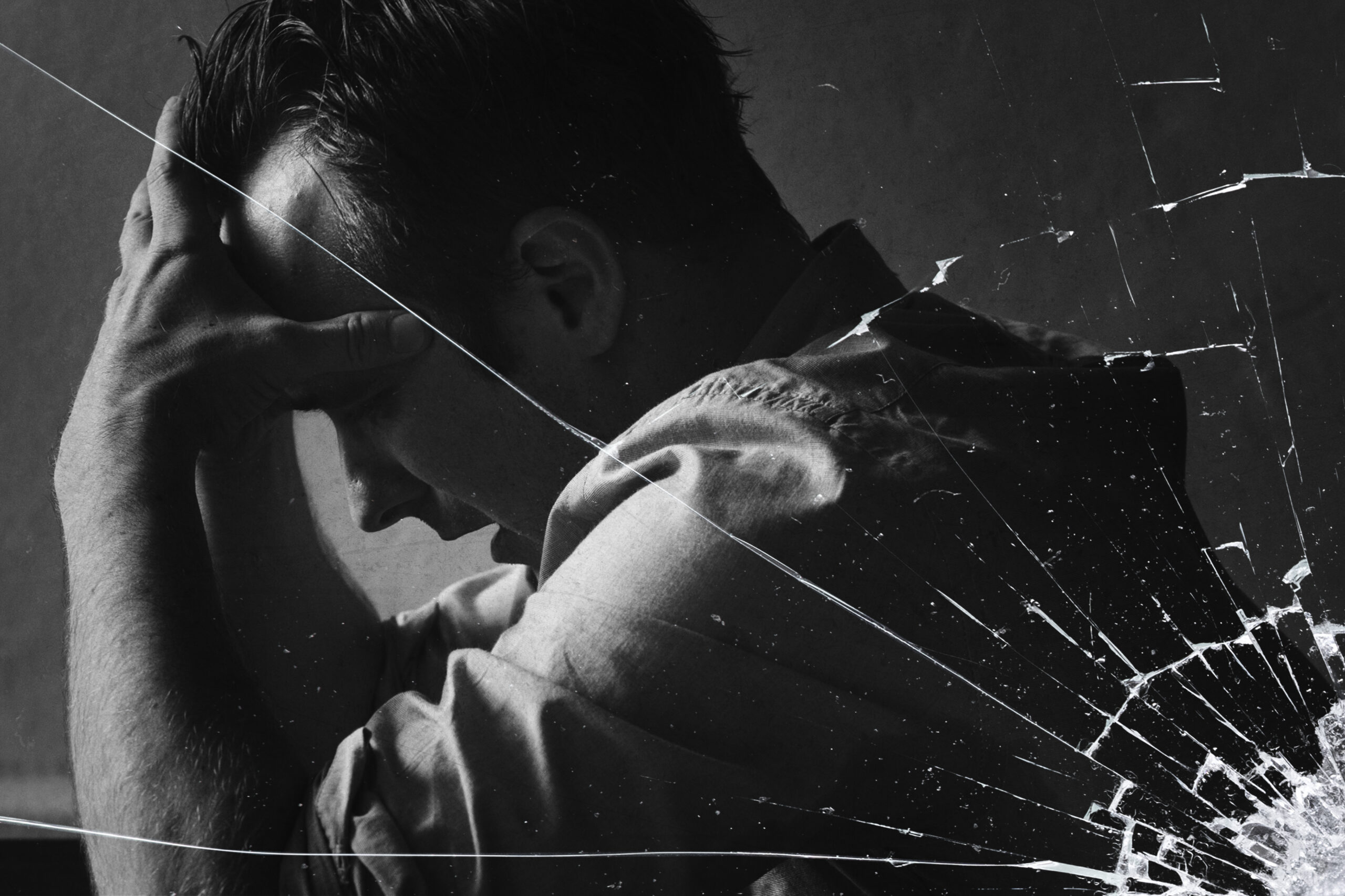 Stressed Man Sitting Hopelessly With Cracked Glass Effect Scaled